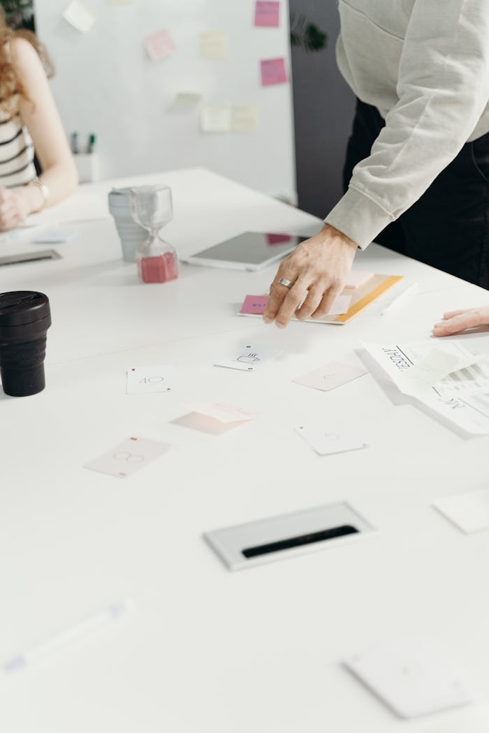 Group collaborating in office with papers and technology for a business strategy session.